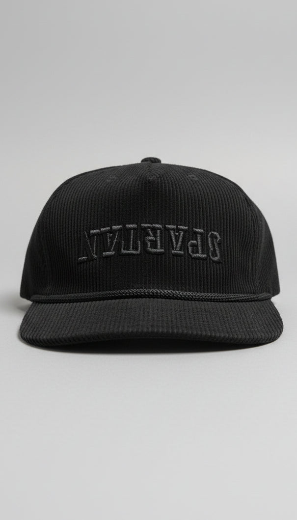 Black corduroy cap with 'Safavian' branding on a textured surface.
